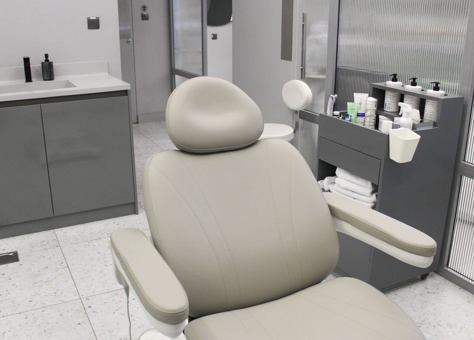 Luxurious treatment room at The Face Only in Dubai, Dubai, AE, featuring a modern spa chair and sleek decor.