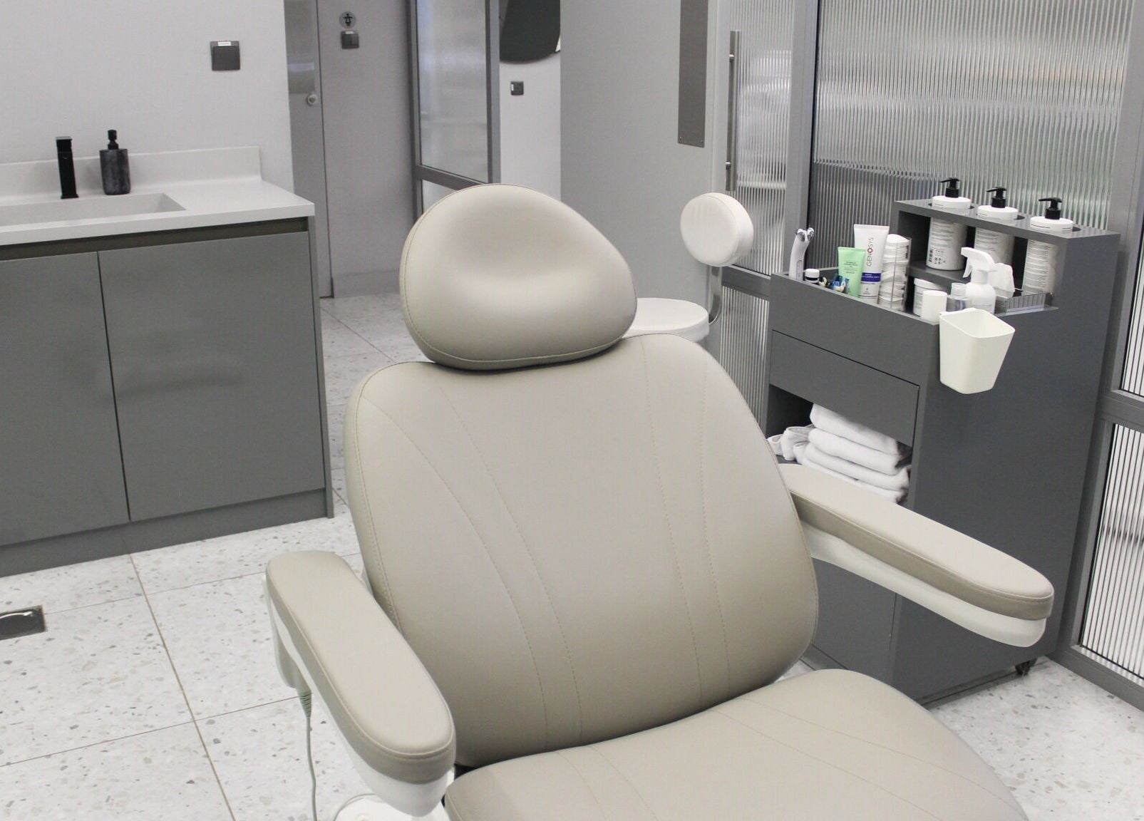 Luxurious treatment room at The Face Only in Dubai, Dubai, AE, featuring a modern spa chair and sleek decor.
