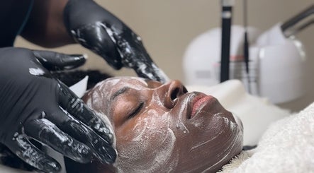 Relaxing facial treatment at Beauty Hideout, Romford, England, GB with gentle hands applying a mask.