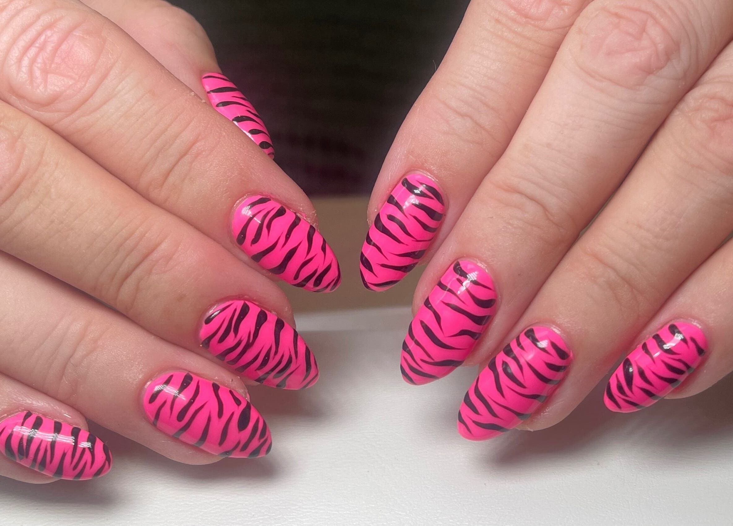 Stylish pink zebra nails by Gee Gee's Beauty, Nantwich, England, GB. Perfect for a bold, trendy look.