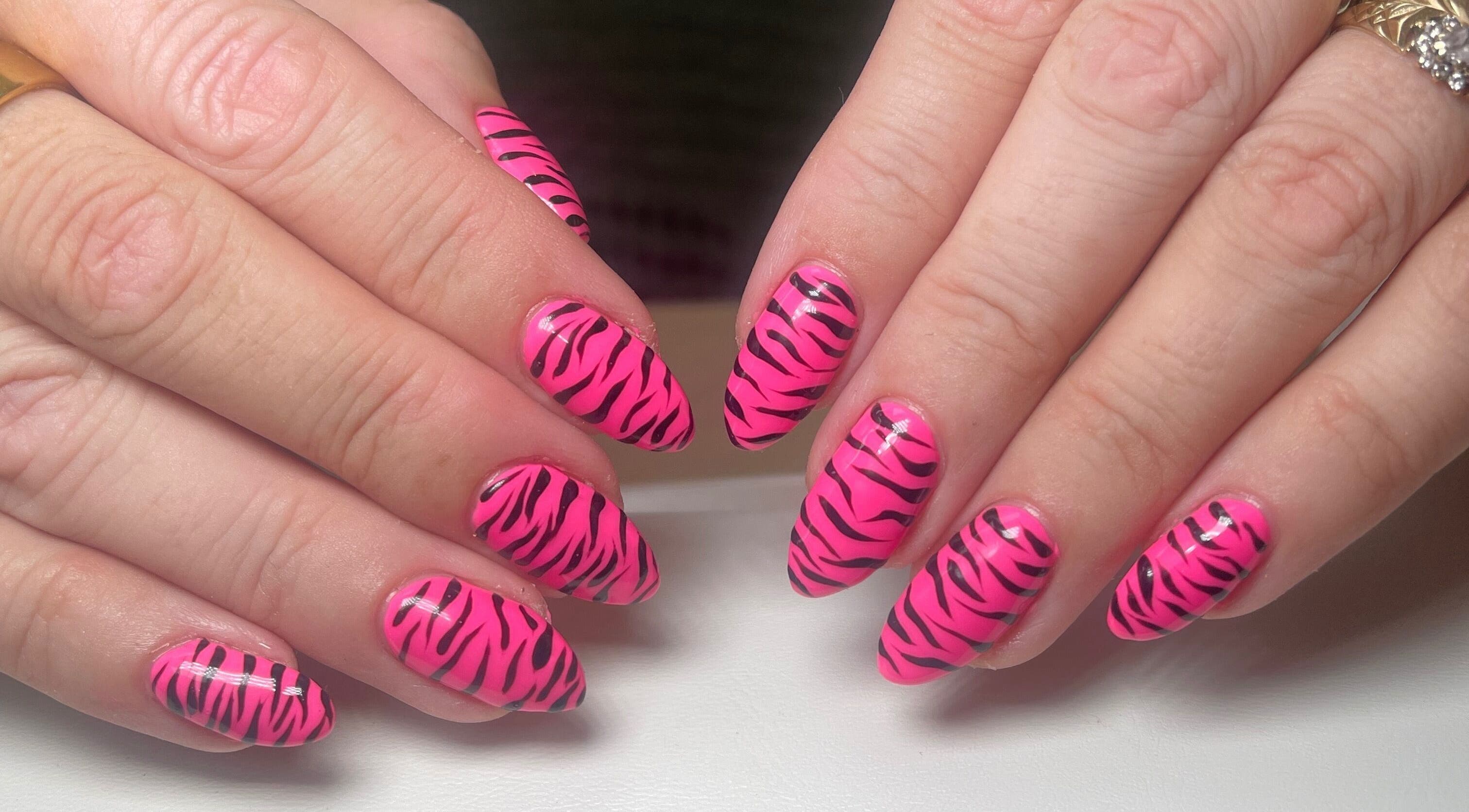 Stylish pink zebra nails by Gee Gee's Beauty, Nantwich, England, GB. Perfect for a bold, trendy look.