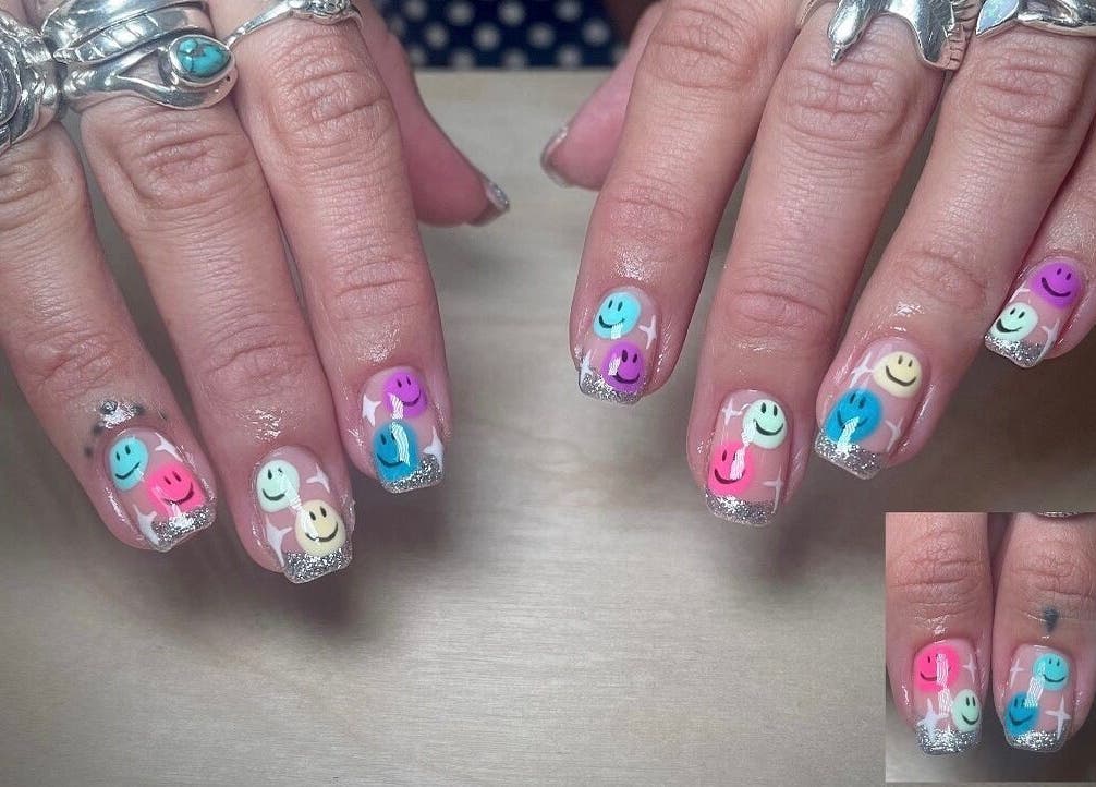Colorful smiley face nail art at Gee Gee's Beauty, Nantwich, England, GB. Bright and playful manicure design.