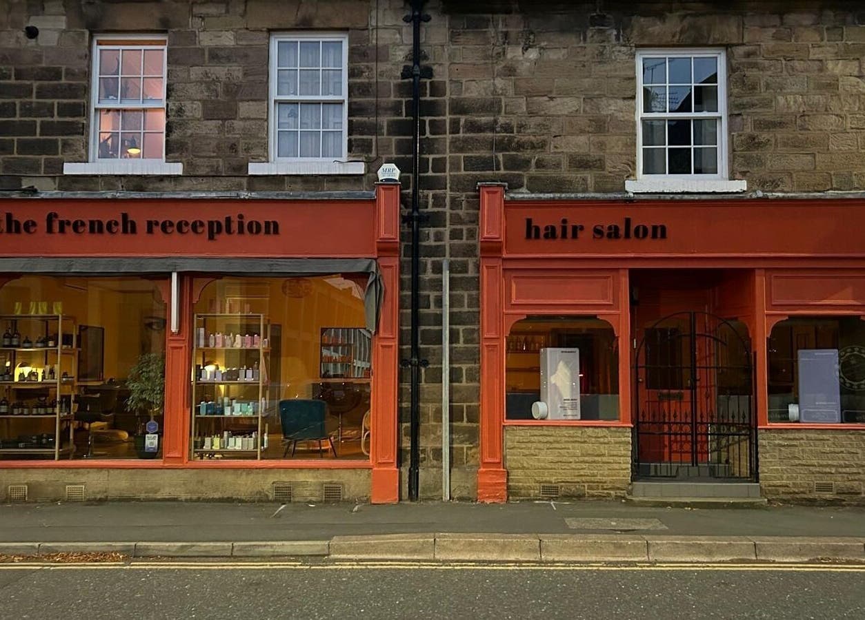The French Reception hair salon exterior in Harrogate, England, GB showcasing stylish beauty product displays.