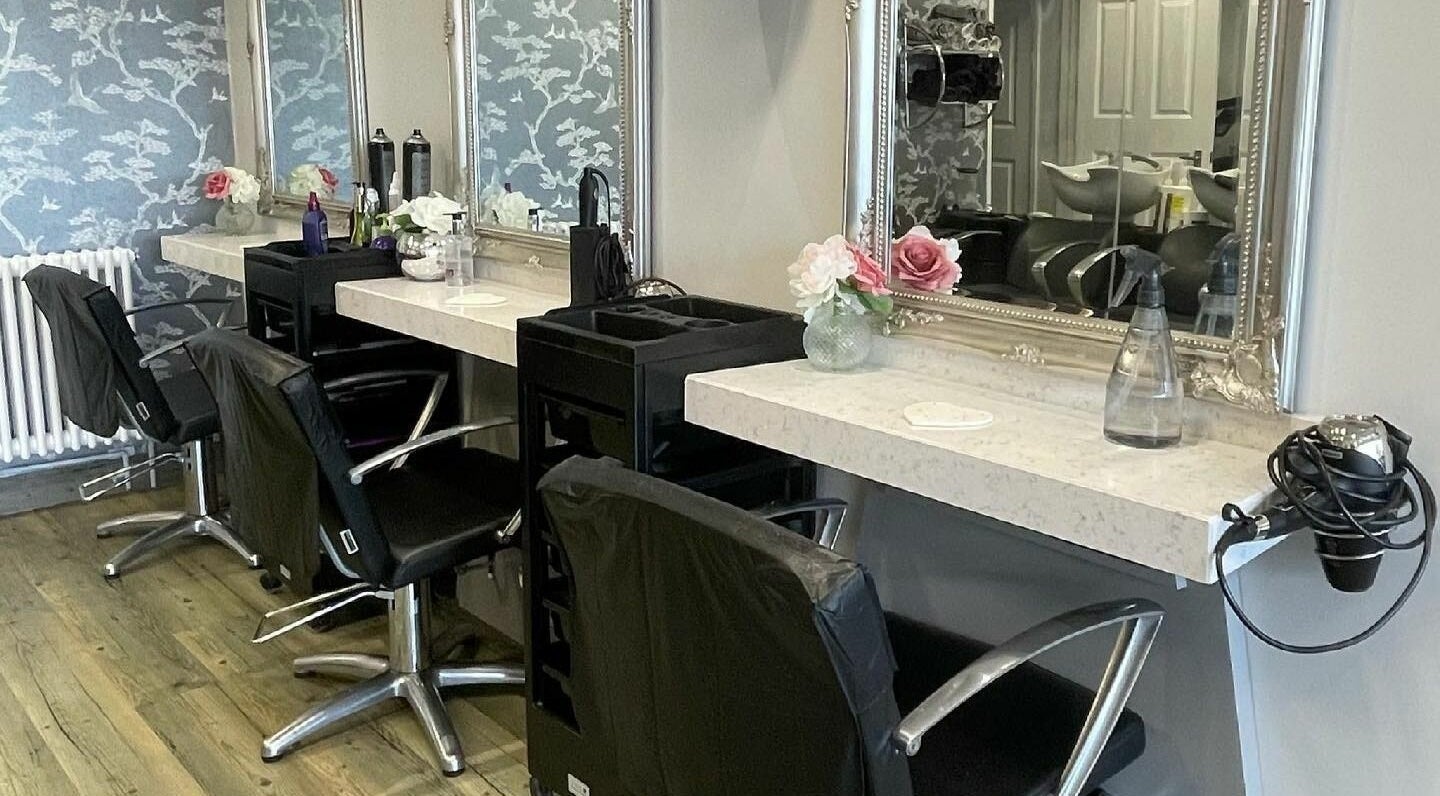 Stylish interior of Milano Hair Salon in Bristol, England, GB, featuring chic salon chairs and mirrors.