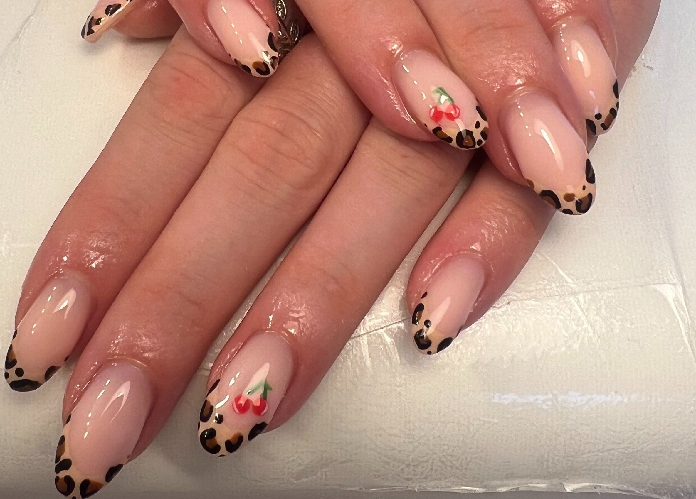 Leopard print nail art with cherry design at Get Glam By Alix Bulloch, Edinburgh, Scotland, GB.