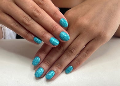 Stylish aqua glitter nails at Cussans Nails & Beauty, Chichester, England, GB.