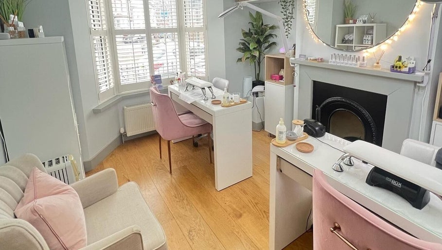 Interior of Cussans Nails & Beauty in Chichester, England, GB featuring elegant nail stations and cozy seating.