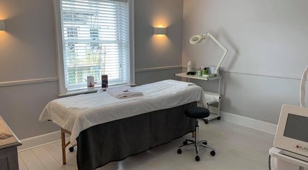 Tranquil treatment room at Cussans Nails & Beauty, Chichester, England, GB with massage table and soft lighting.