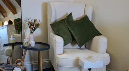 Plush seating area at Cussans Nails & Beauty, Chichester, England, GB with green cushions and elegant decor.