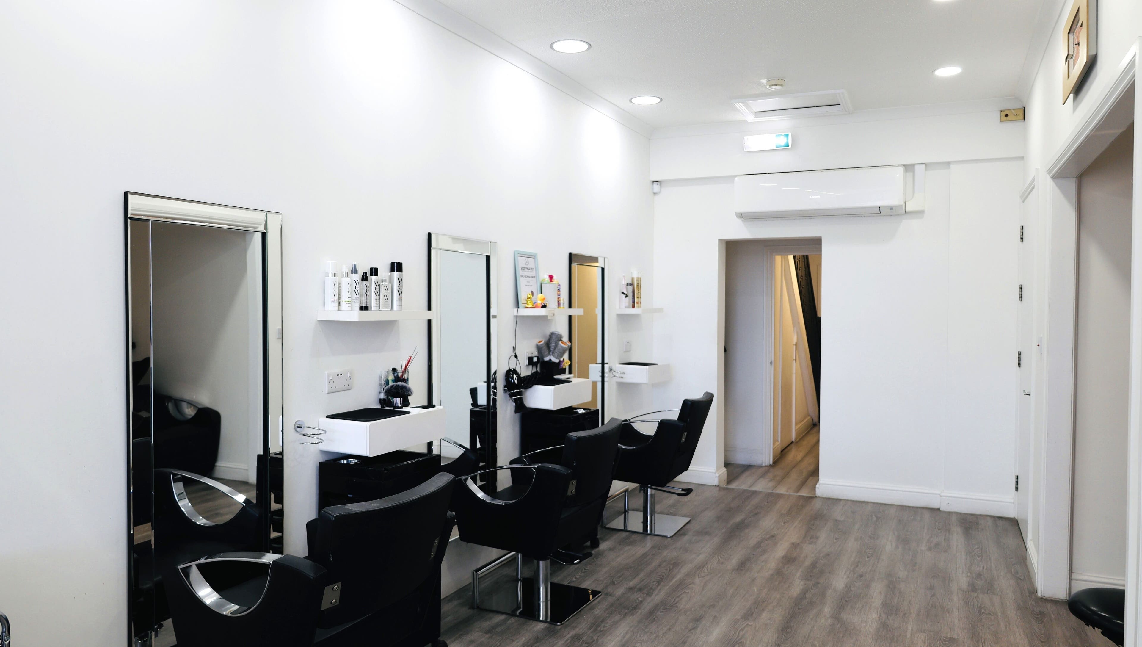 Elegant salon interior at Sunrayz Hair & Beauty, Hornchurch, England, GB with modern chairs and mirrors.