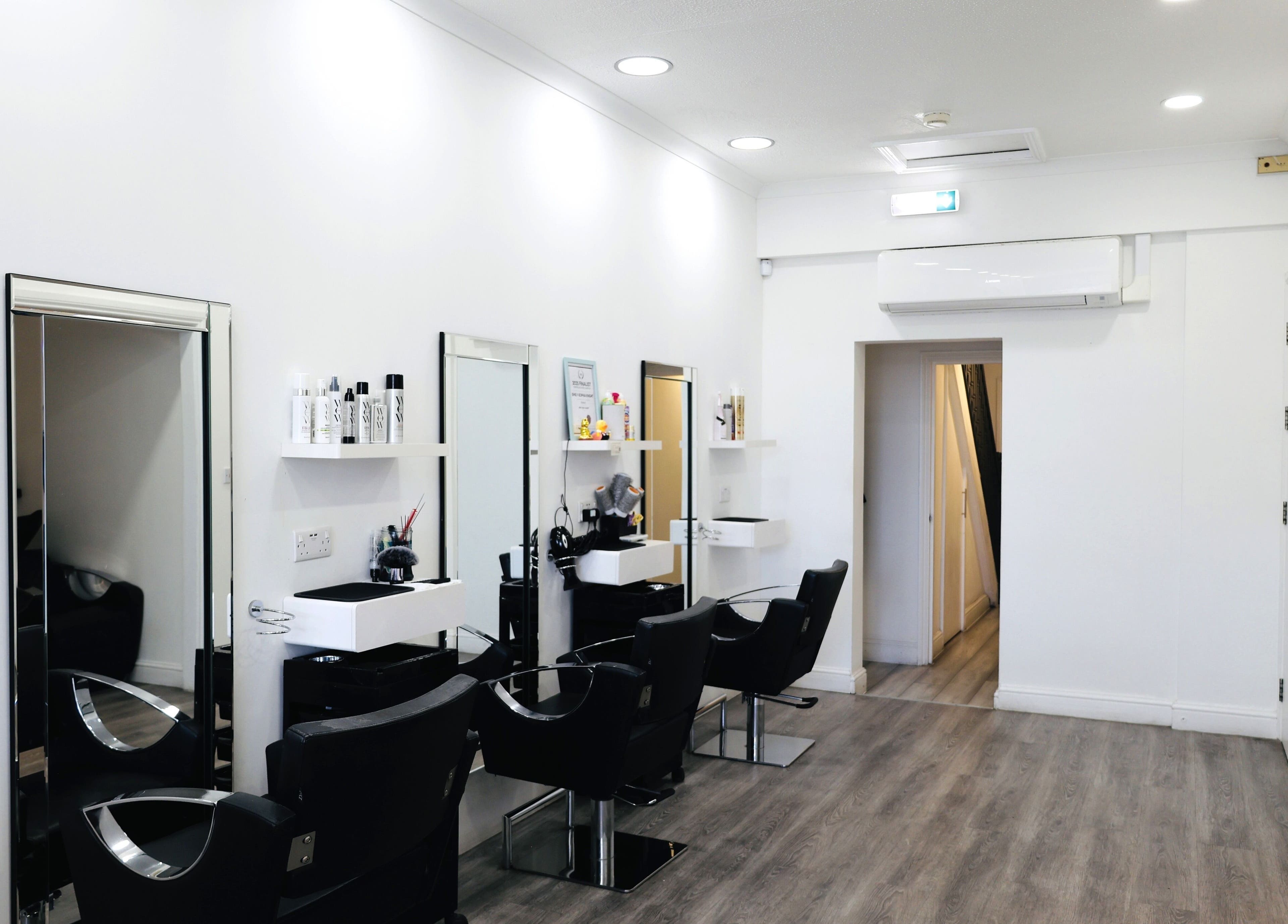 Elegant salon interior at Sunrayz Hair & Beauty, Hornchurch, England, GB with modern chairs and mirrors.