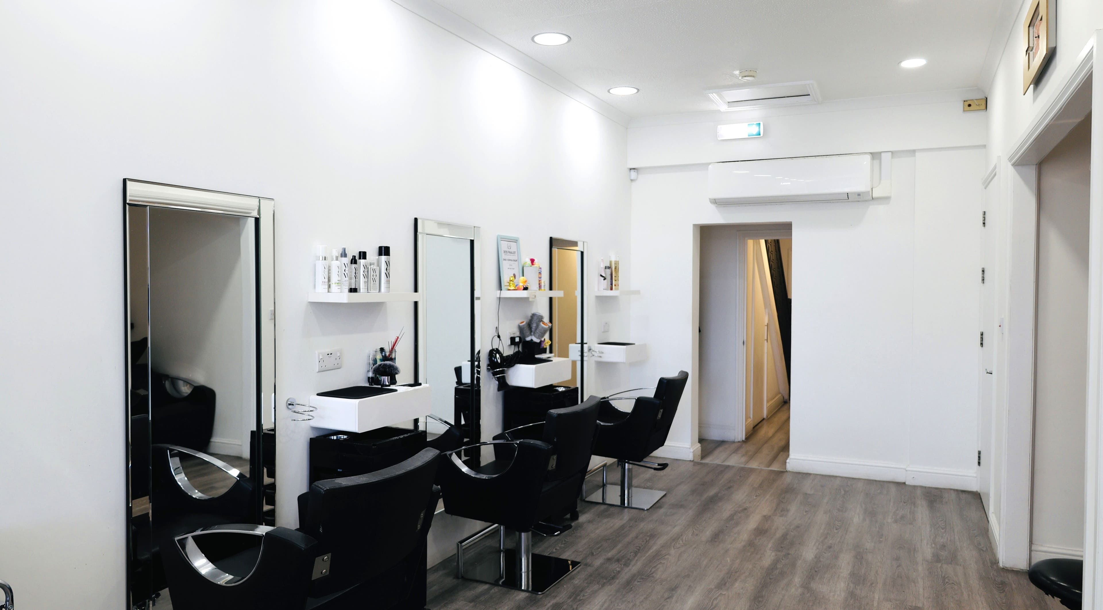 Elegant salon interior at Sunrayz Hair & Beauty, Hornchurch, England, GB with modern chairs and mirrors.