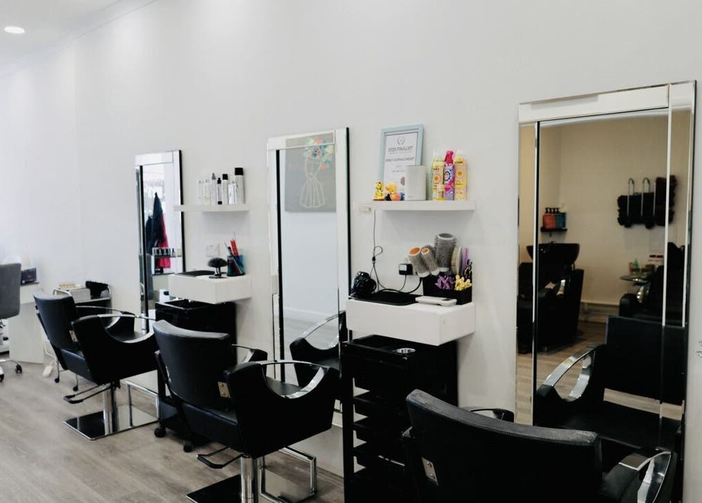 Modern salon interior at Sunrayz Hair & Beauty, Hornchurch, England, GB featuring sleek styling stations.