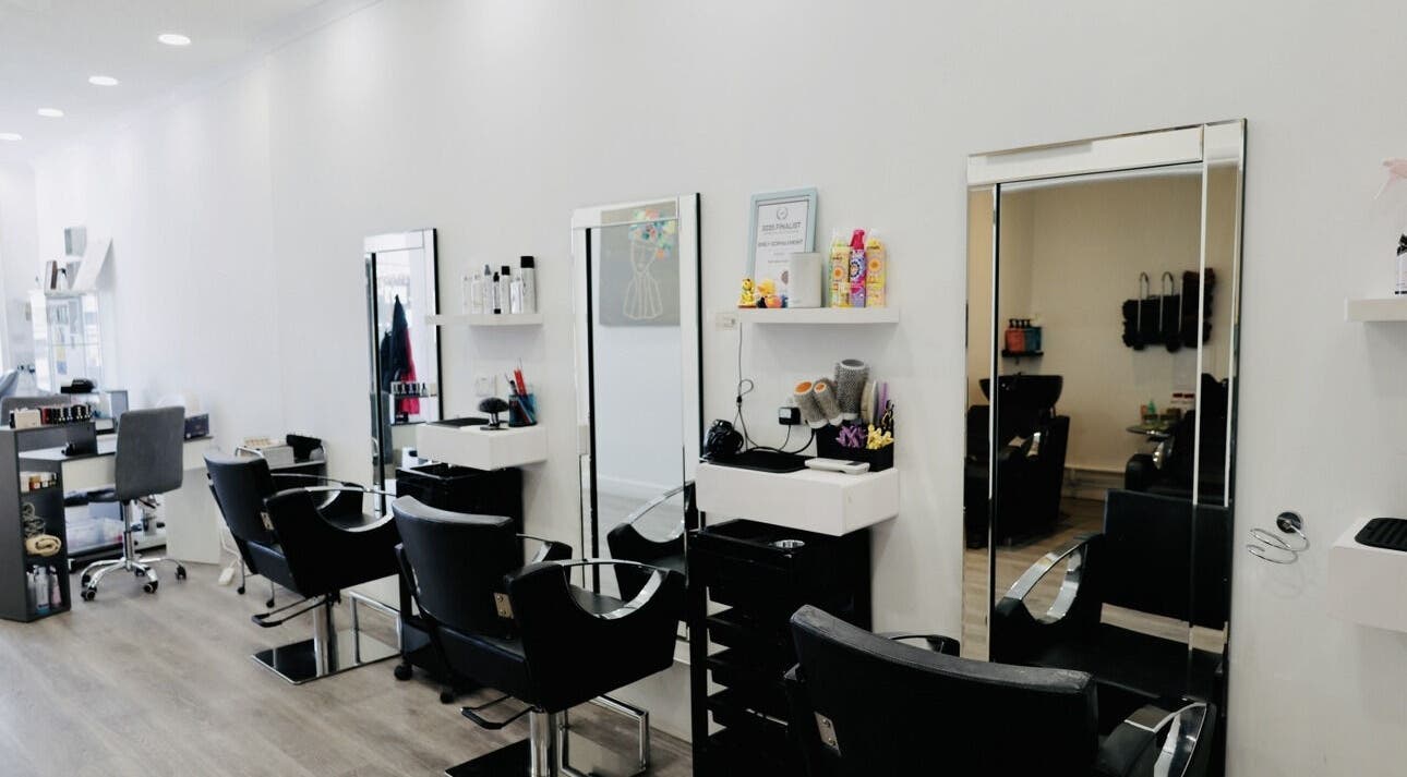 Modern salon interior at Sunrayz Hair & Beauty, Hornchurch, England, GB featuring sleek styling stations.