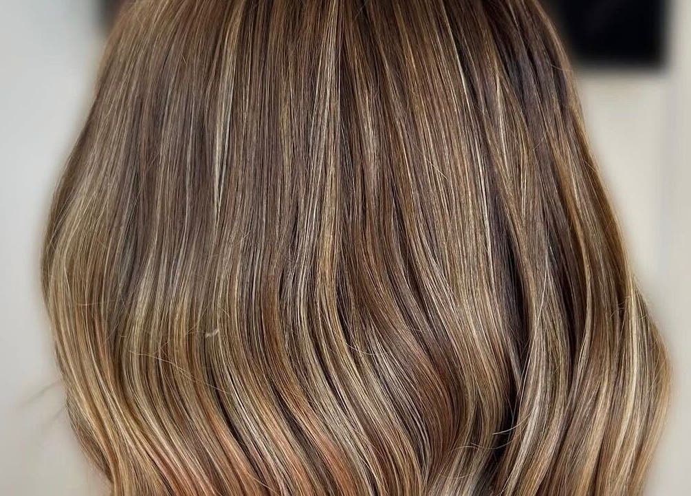 Elegant brown hair styling at Sunrayz Hair & Beauty, Hornchurch, England, GB showcasing silky highlights.