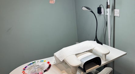 Nail table setup at Soothe & Glow, Bletchley, England, GB, featuring nail polish samples and manicure tools.