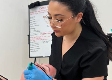 Beauty therapist performing facial treatment at Soothe & Glow, Bletchley, England, GB.