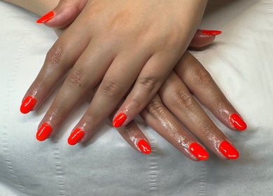 Bright red manicure at Soothe & Glow, Bletchley, England, GB, showcasing vibrant nail art.