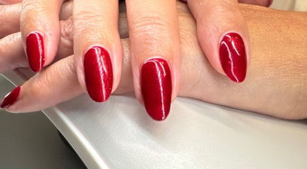 Elegant red manicure at Soothe & Glow, Bletchley, England, GB, showcasing impeccable nail artistry.
