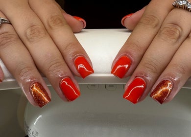 Vibrant red and bronze manicure at Soothe & Glow, Bletchley, England, GB showcasing elegant nail art.