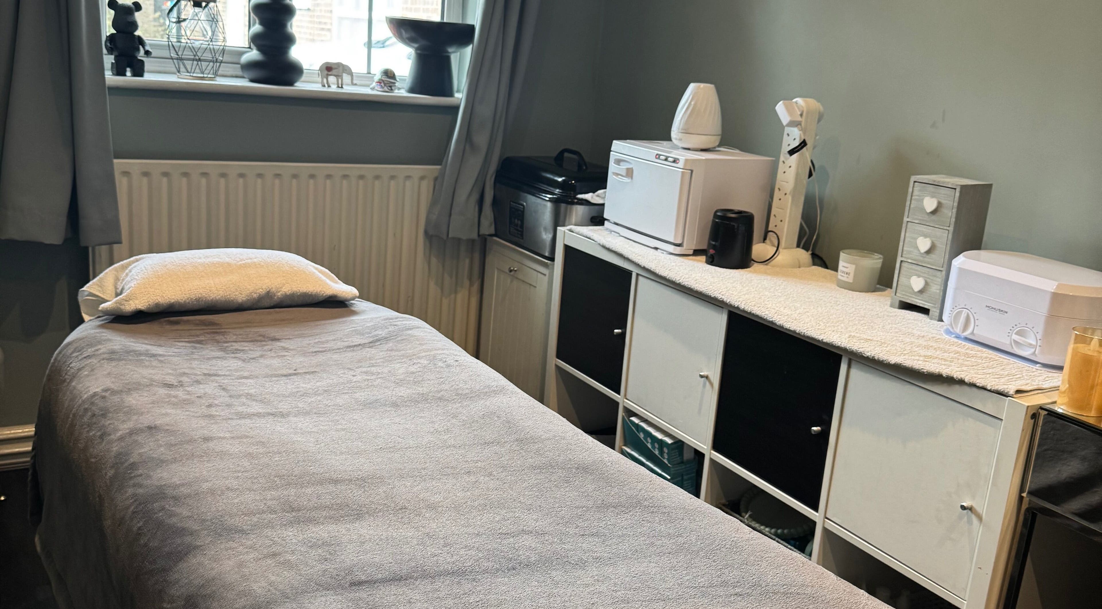 Relaxing massage room at Soothe & Glow in Bletchley, England, GB, featuring a comfy massage table.