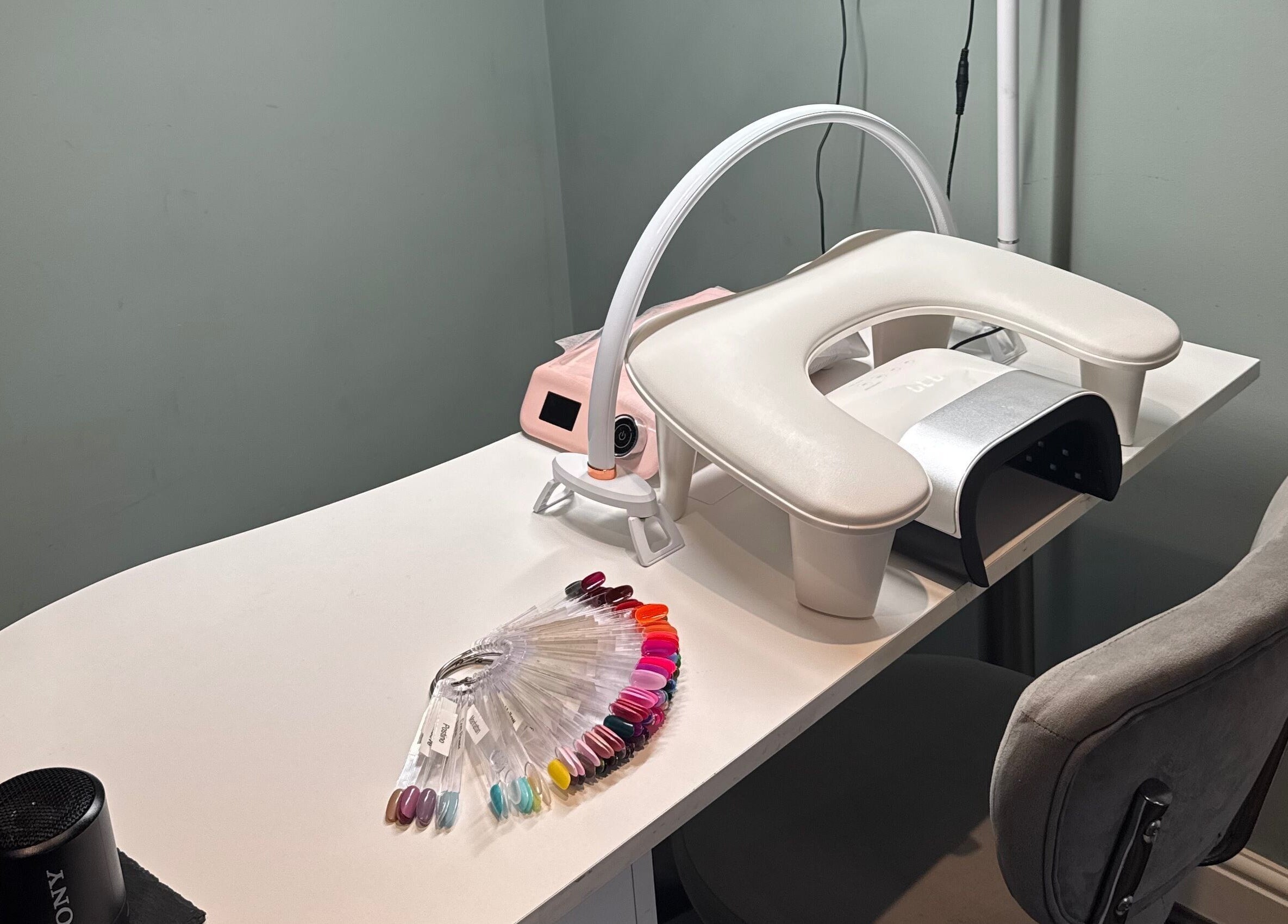 Modern nail station at Soothe & Glow, Bletchley, England, GB, featuring colorful nail polish options.