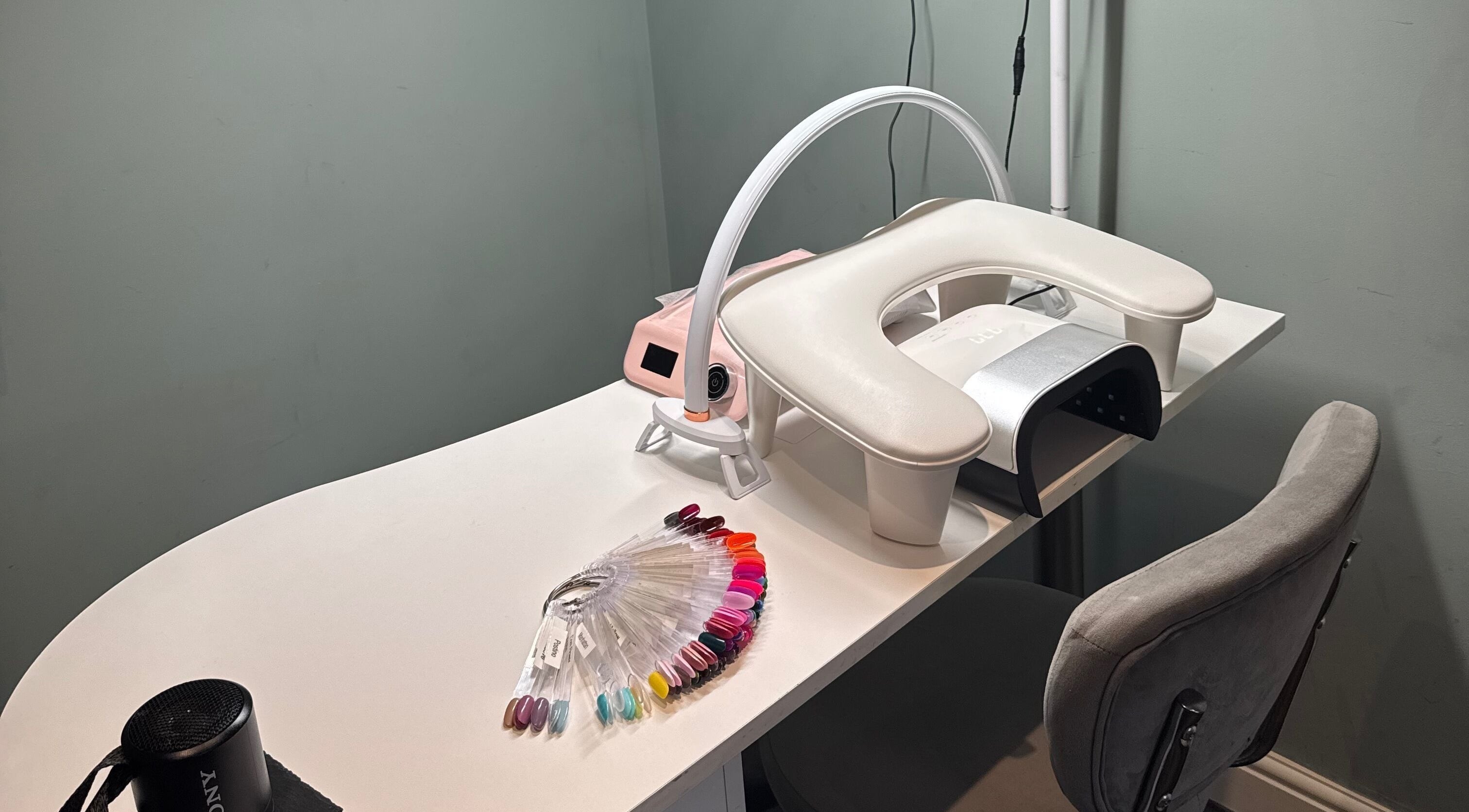 Modern nail station at Soothe & Glow, Bletchley, England, GB, featuring colorful nail polish options.