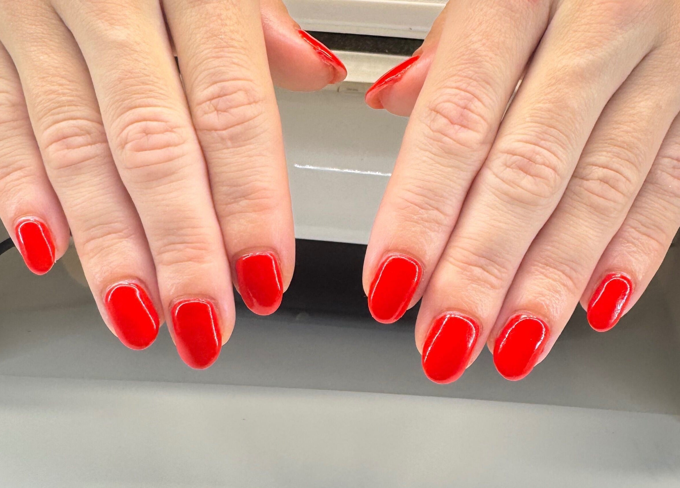 Vibrant red manicure at Soothe & Glow in Bletchley, England, GB perfectly showcases elegant nail services.