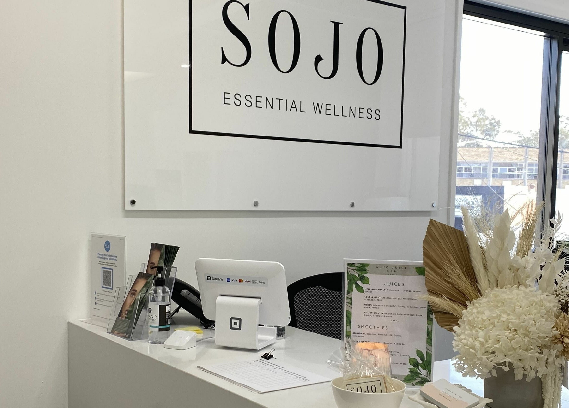 Reception area at SOJO Essential Wellness in Botany, NSW, AU, featuring modern decor and natural elements.