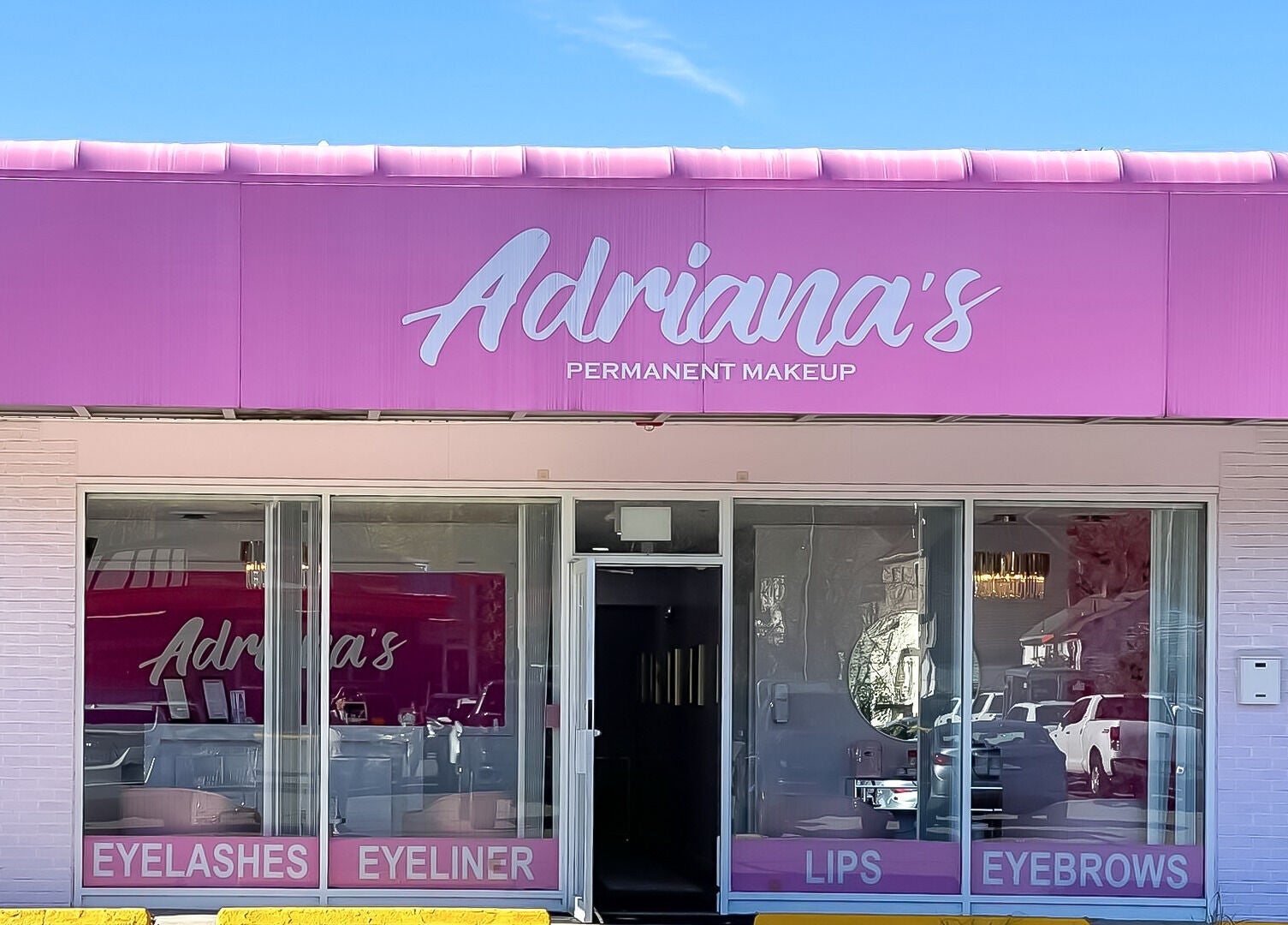 Front view of Adriana's Permanent Makeup in Wilmington, Massachusetts, US, showcasing a vibrant pink storefront.