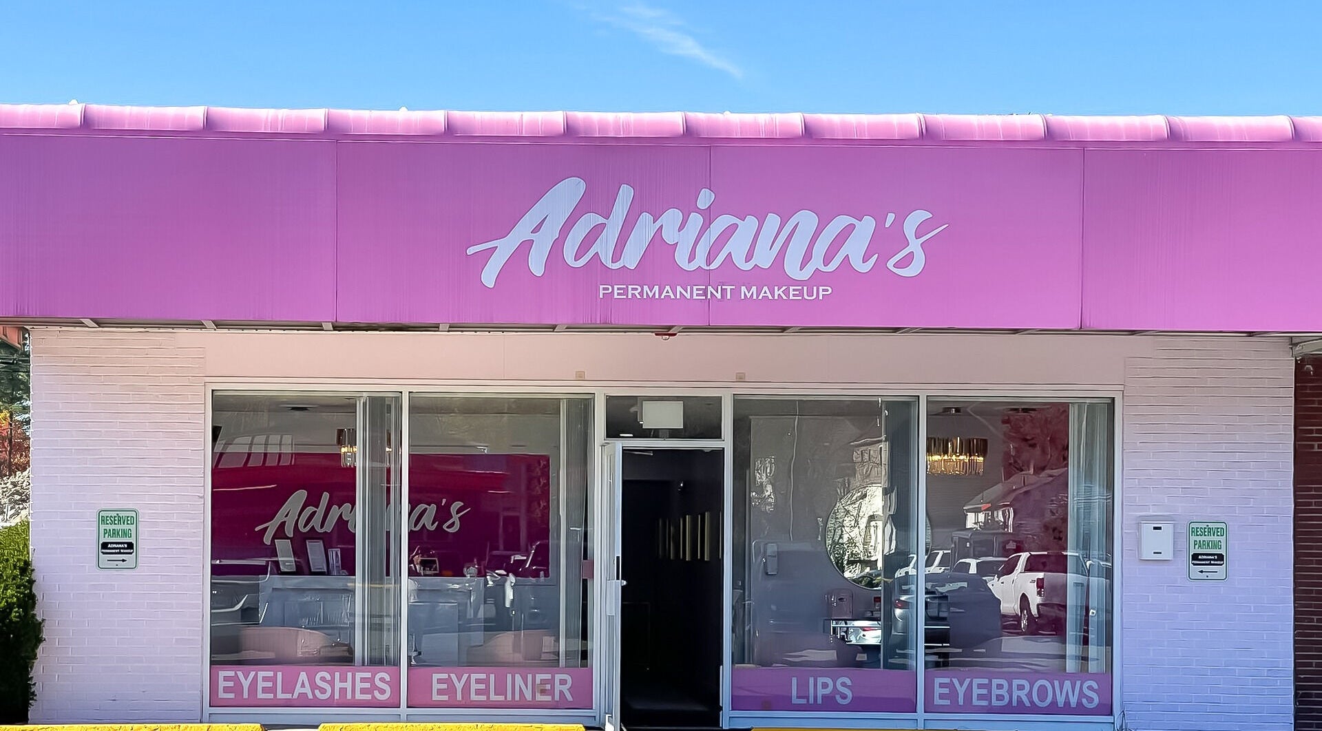Front view of Adriana's Permanent Makeup in Wilmington, Massachusetts, US, showcasing a vibrant pink storefront.