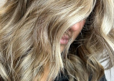 Close-up of styled, wavy blonde hair at The Glambar, Glasgow, Scotland, GB.