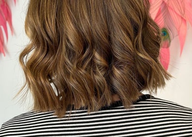 Stylish wavy hairstyle at The Glambar in Glasgow, Scotland, GB, showcasing modern elegance and chic design.