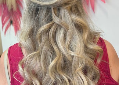 Elegant wavy hairstyle at The Glambar, Glasgow, Scotland, GB, showcasing blonde curls.