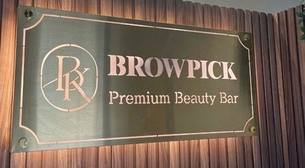Elegant Browpick Beauty Bar sign in Port Moody, British Columbia, CA with a stylish wooden background.