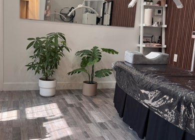 Browpick Beauty Bar & Spa in Port Moody, BC, offers a serene treatment room with comfy table and lush plants.
