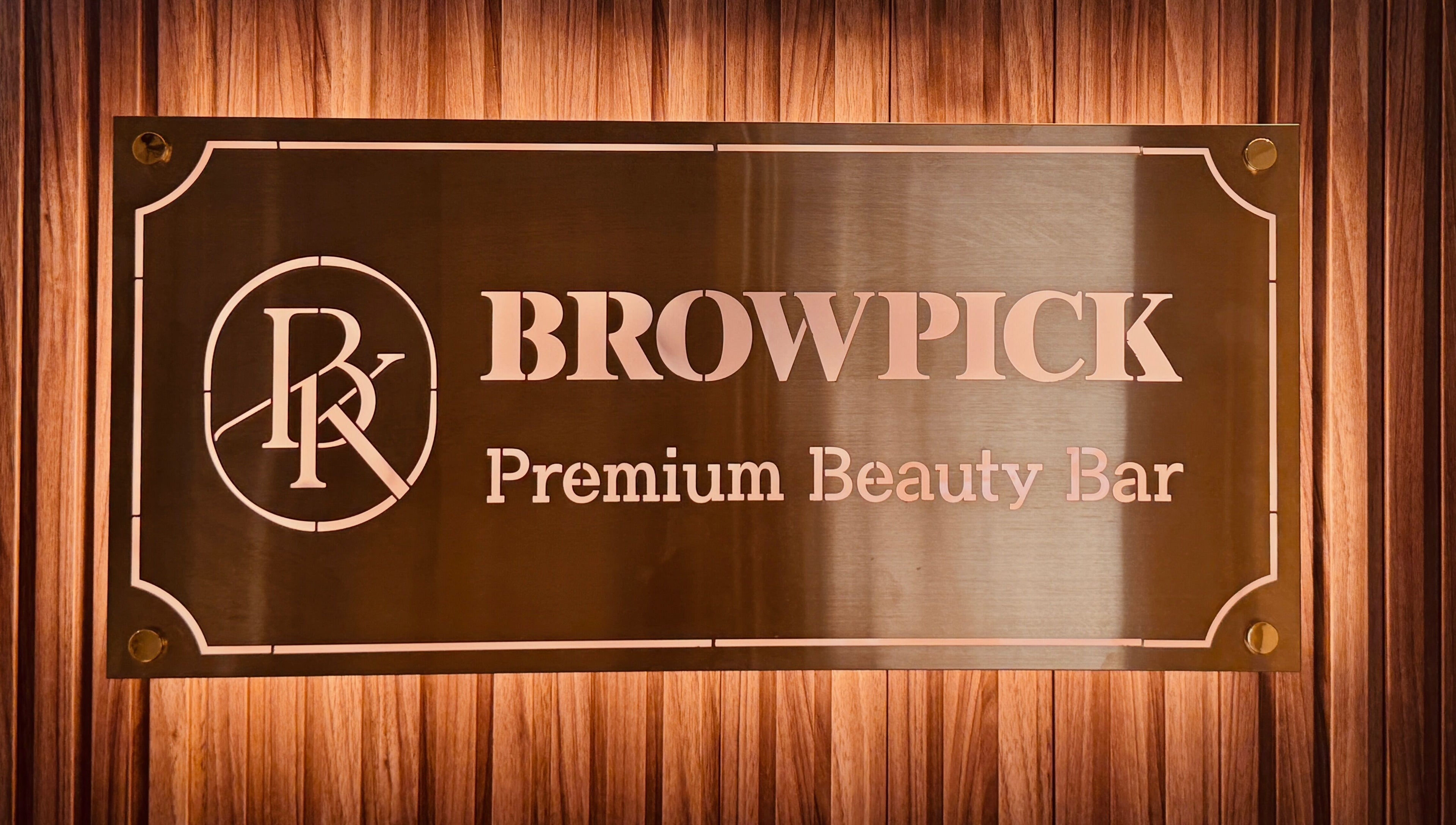 Browpick Beauty Bar & Spa sign in Port Moody, British Columbia, CA, with elegant wood backdrop.