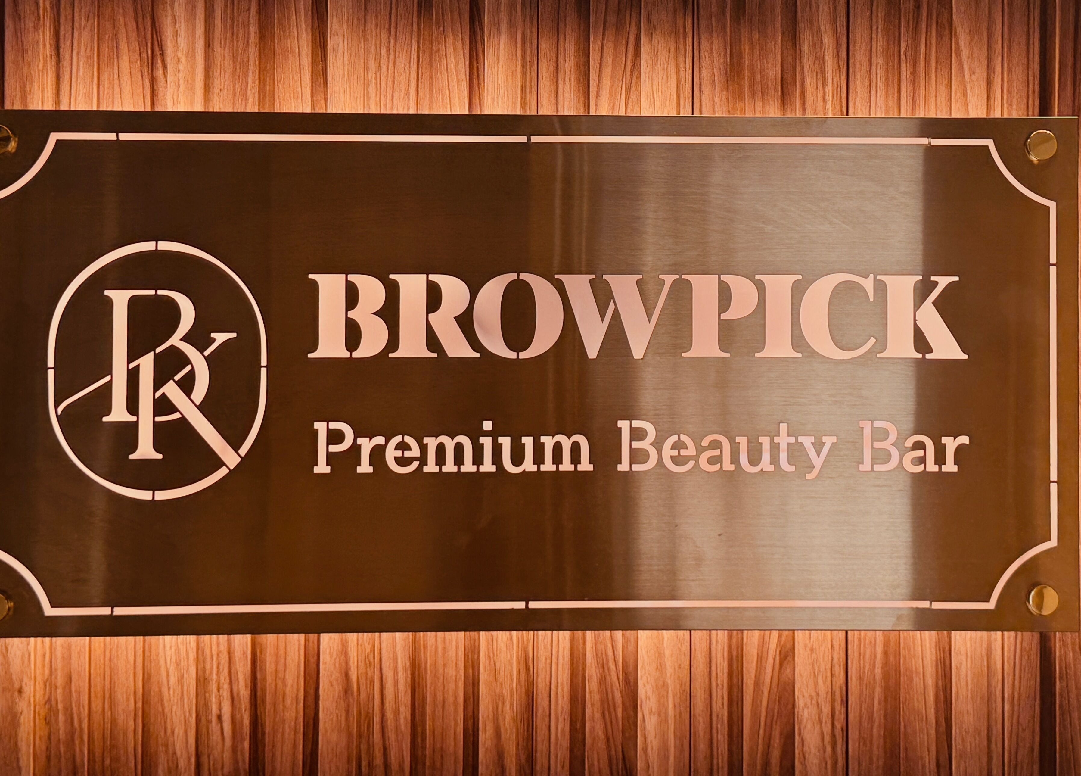 Browpick Beauty Bar & Spa sign in Port Moody, British Columbia, CA, with elegant wood backdrop.