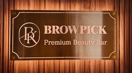 Browpick Beauty Bar & Spa sign in Port Moody, British Columbia, CA, with elegant wood backdrop.
