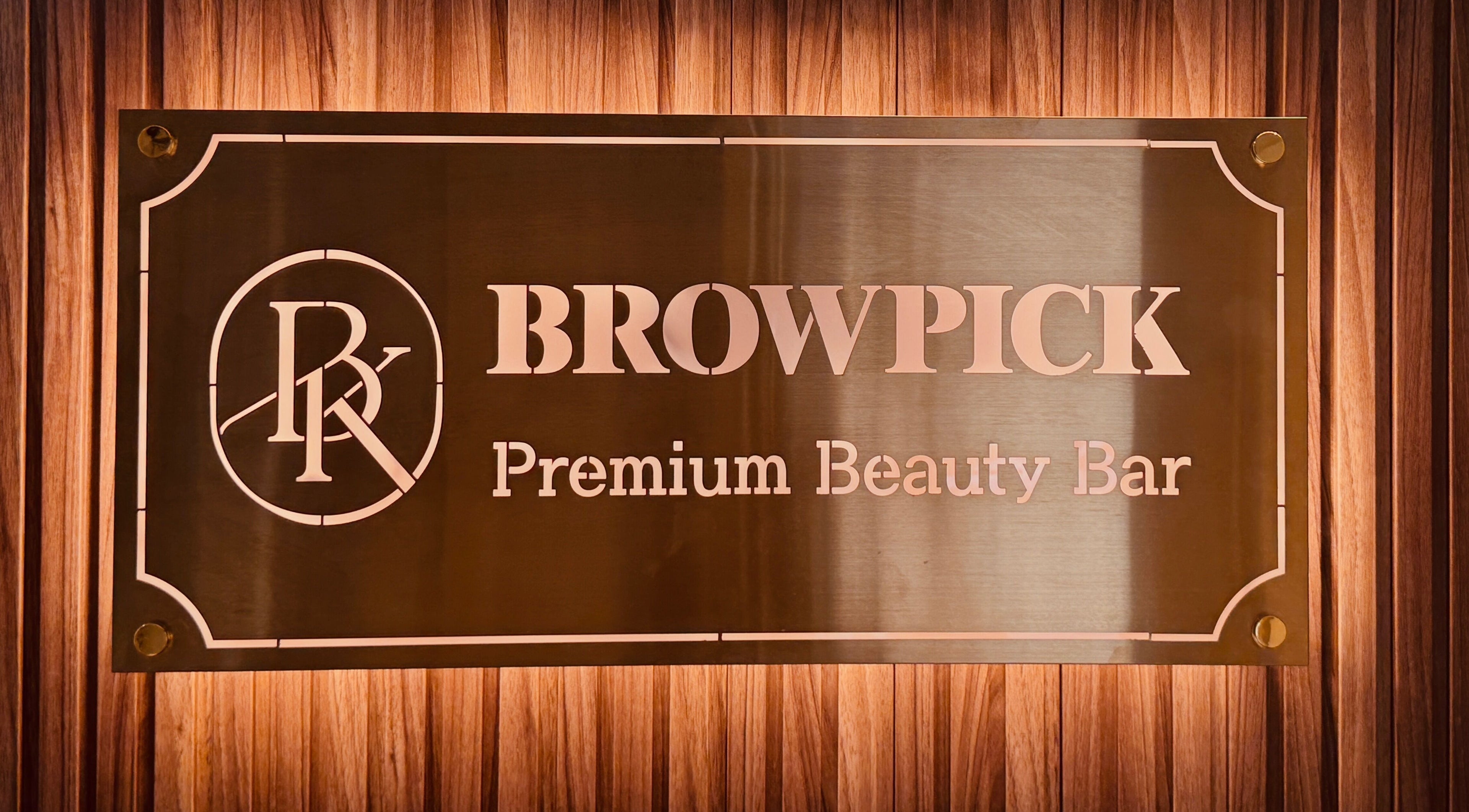 Browpick Beauty Bar & Spa sign in Port Moody, British Columbia, CA, with elegant wood backdrop.