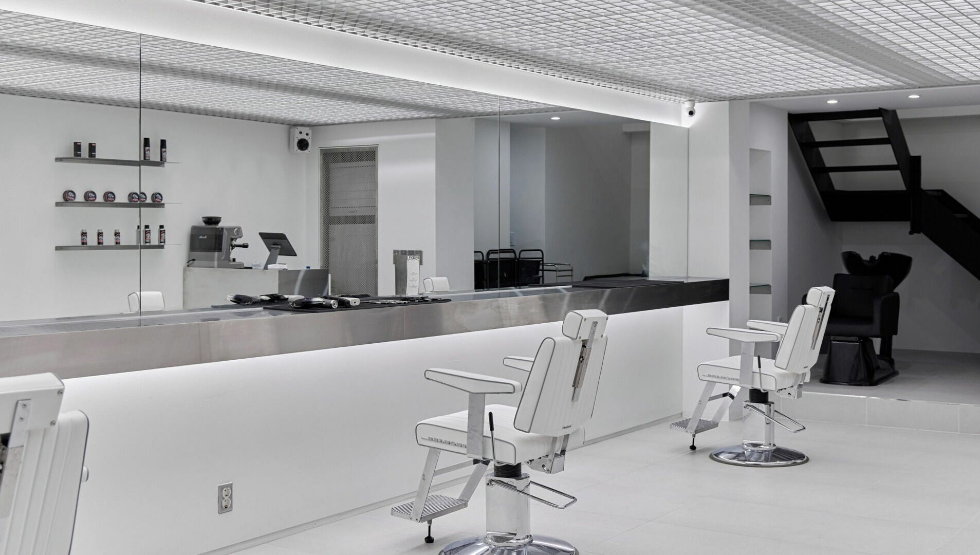 Modern salon interior at LEKKER Hongdae, Seoul, Seoul, KR, featuring sleek chairs and minimalistic design.