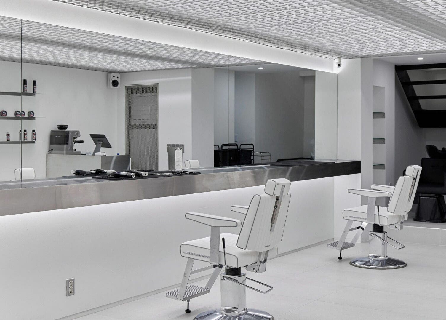 Modern salon interior at LEKKER Hongdae, Seoul, Seoul, KR, featuring sleek chairs and minimalistic design.