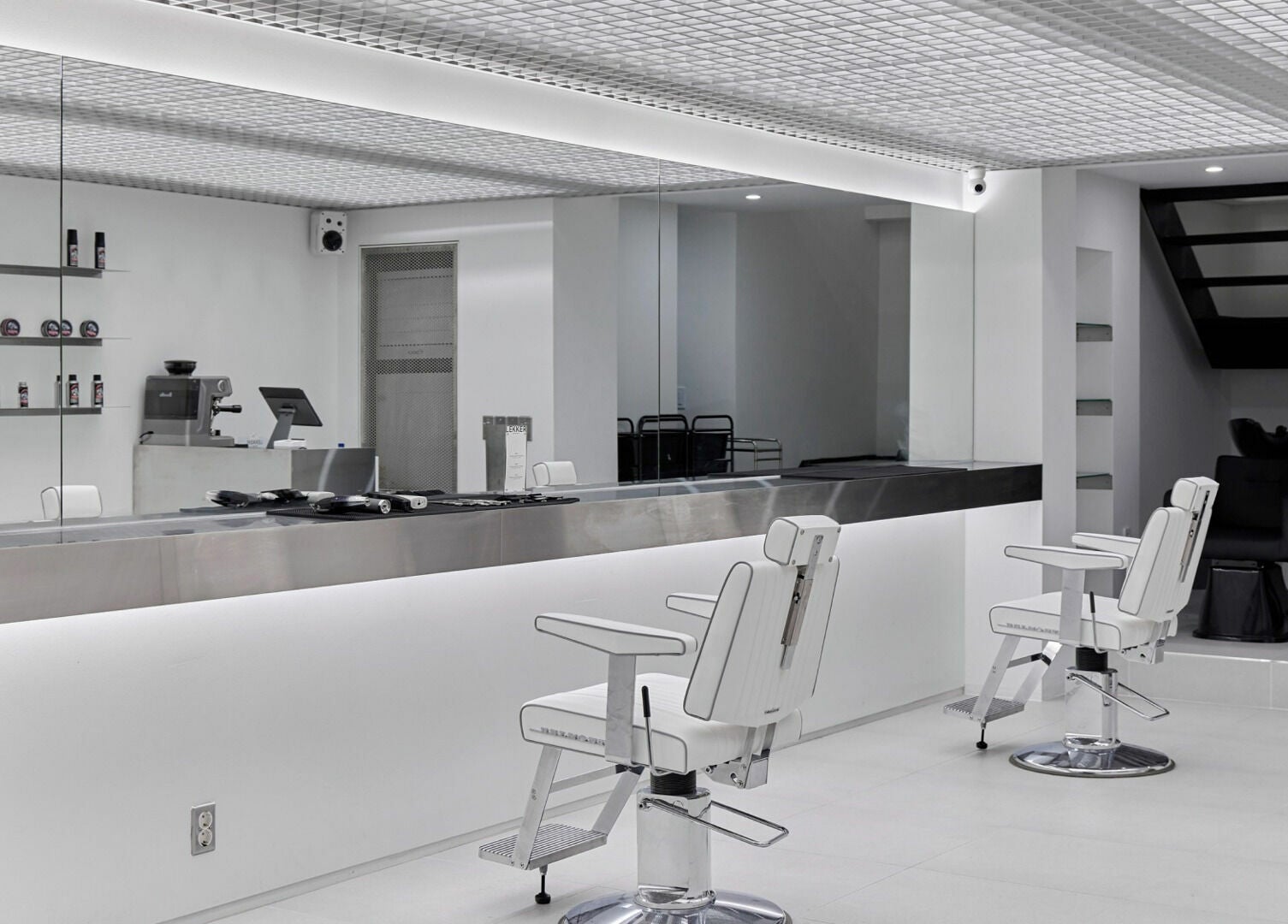 Modern salon interior at LEKKER Hongdae, Seoul, Seoul, KR, featuring sleek chairs and minimalistic design.