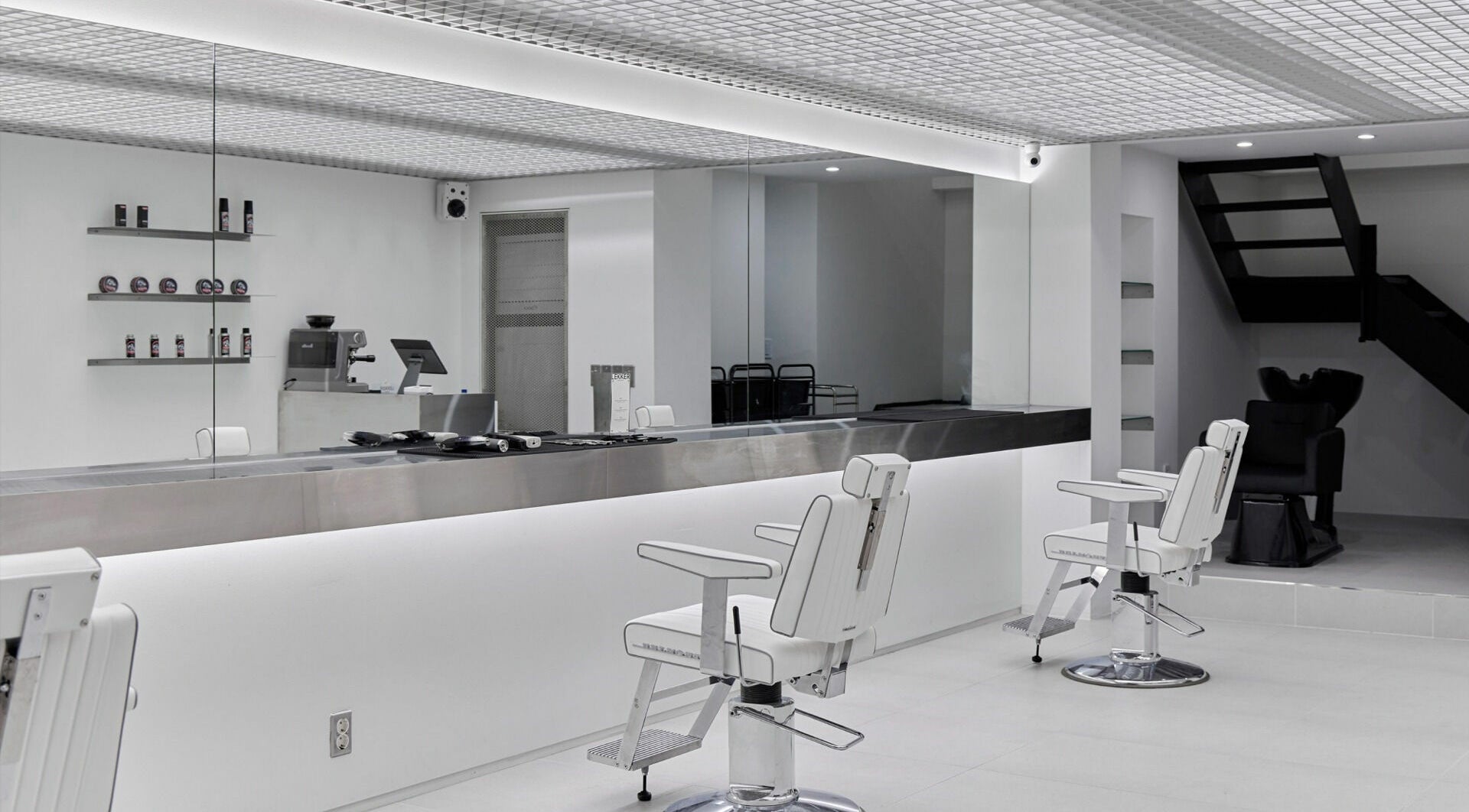 Modern salon interior at LEKKER Hongdae, Seoul, Seoul, KR, featuring sleek chairs and minimalistic design.