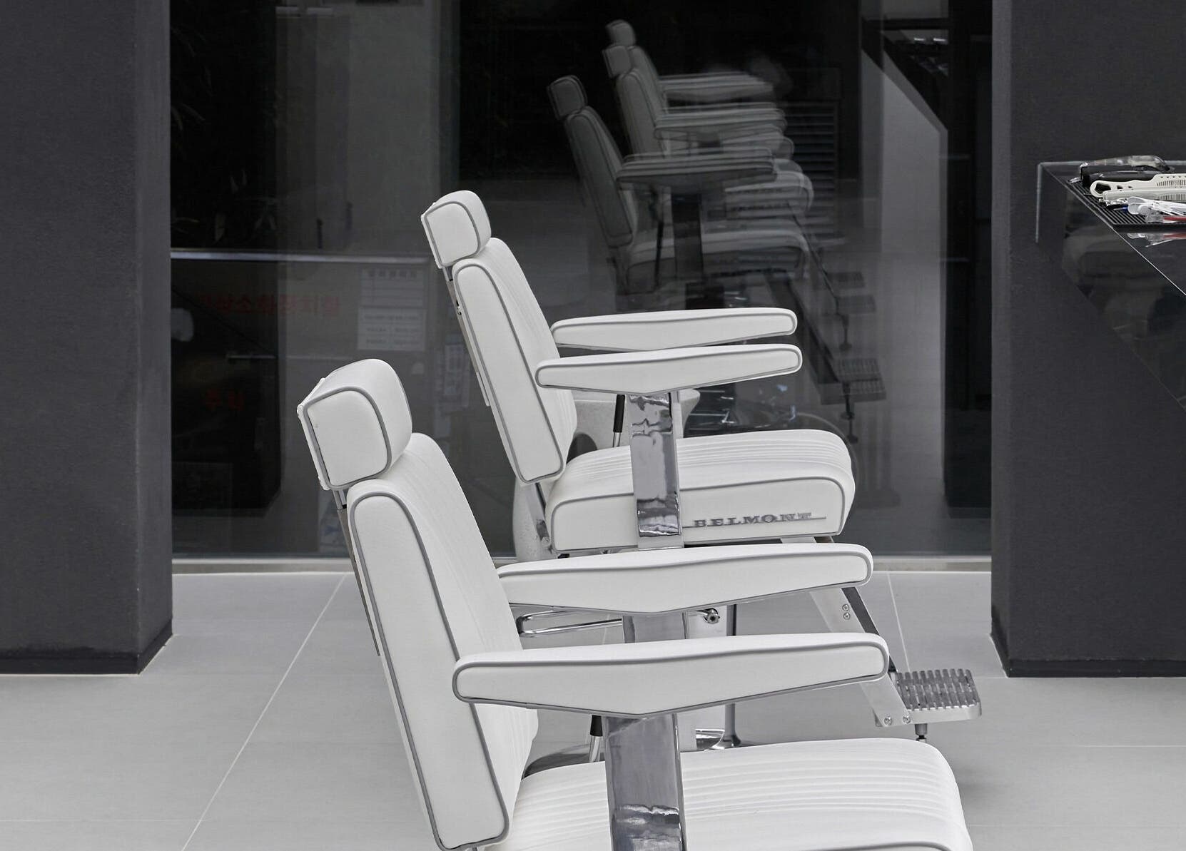 Modern white salon chairs at LEKKER Hongdae, Seoul, Seoul, KR, offering chic and comfortable styling.