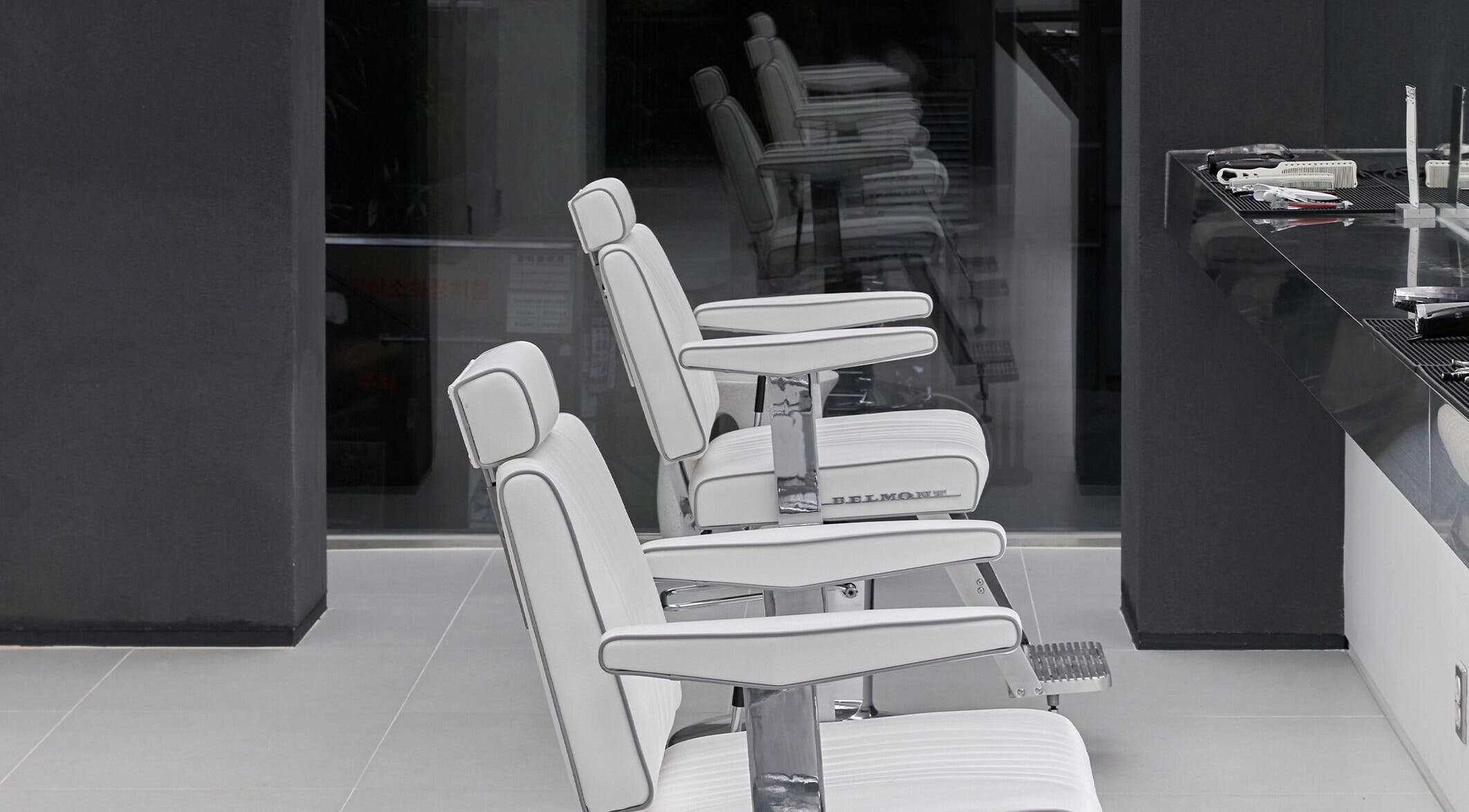 Modern white salon chairs at LEKKER Hongdae, Seoul, Seoul, KR, offering chic and comfortable styling.
