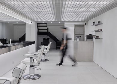 Modern interior of LEKKER Gangnam, a sleek beauty salon in Seoul, Seoul, KR featuring stylish barber chairs.