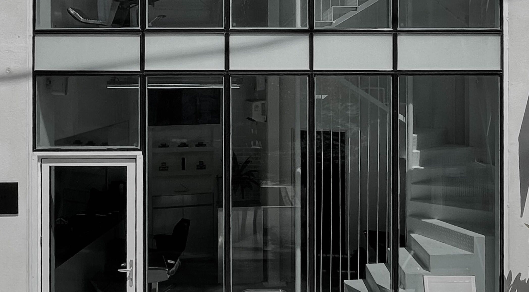 LEKKER Itaewon entrance in Seoul, Seoul, KR, showcasing sleek glass facade and interior staircase.