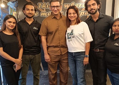 Team members of Avaa_Kandivali smiling together at the venue in Mumbai, Maharashtra, IN.