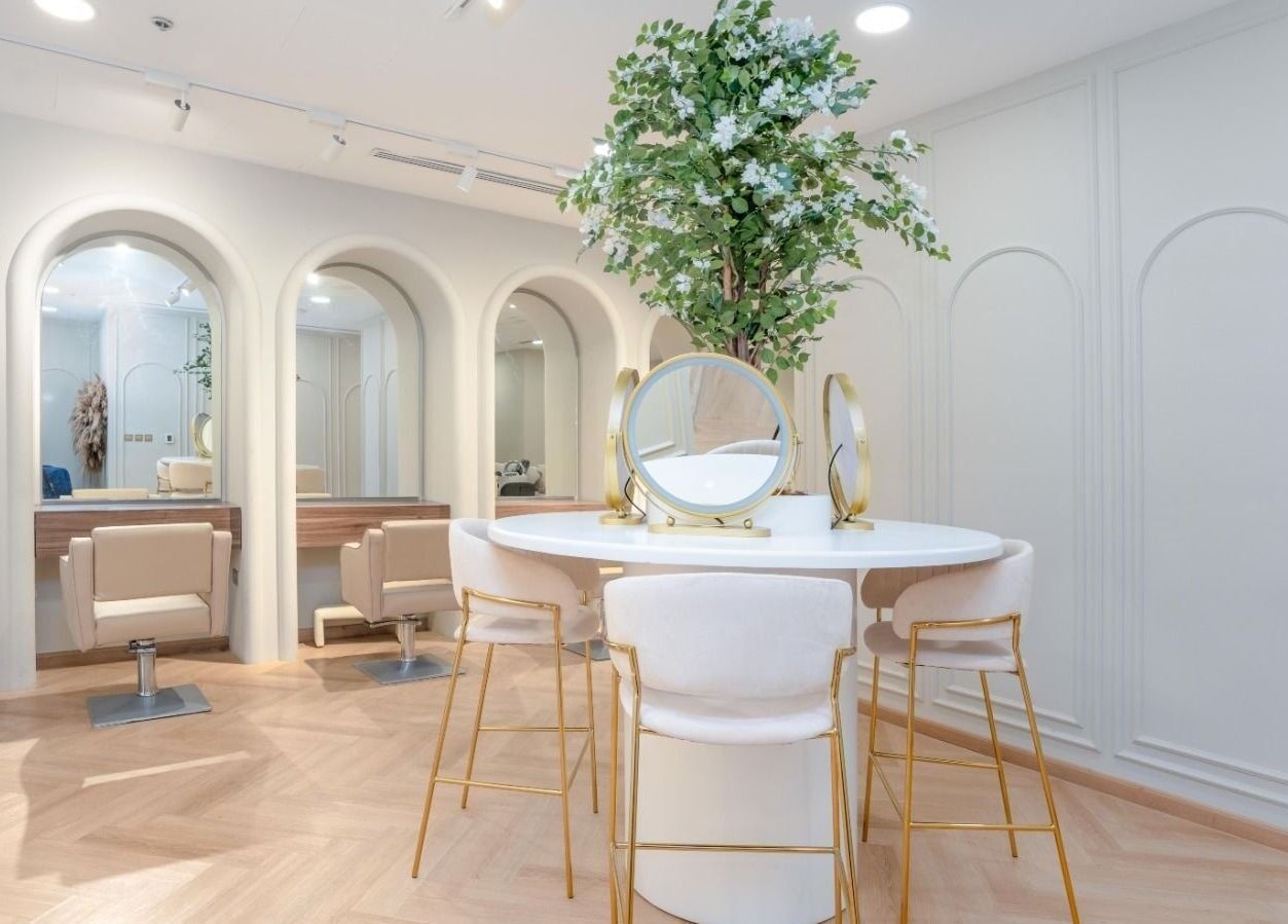 Elegant salon interior at La Beauté, Dubai, AE with stylish seating and lush decor.